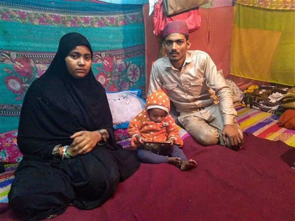 The infant's parents, Mohammed Arif and Nazia, at Shaheen Bagh area with their other child. (Photo: PTI)