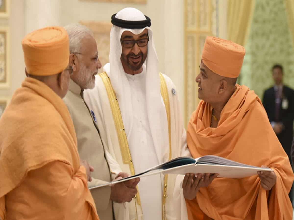 Crown Prince HH Mohamed bin Zayed al Nahyan and PM Narendra Modi are shown a book outlining the temple project Image Courtesy: BASP.Org