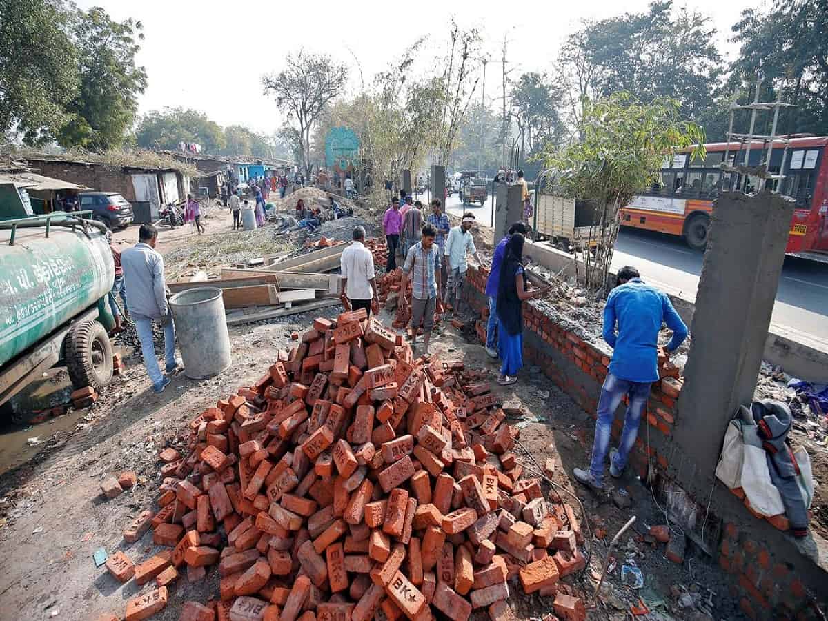 Wall being constructed to cover slum area in Gujarat
