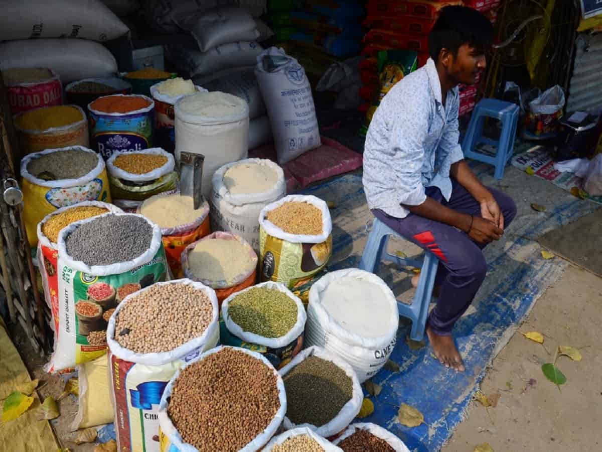 An Indian shopkeeper selling grains and legums waits for customers at a market in Allahabad. Photo: AFP