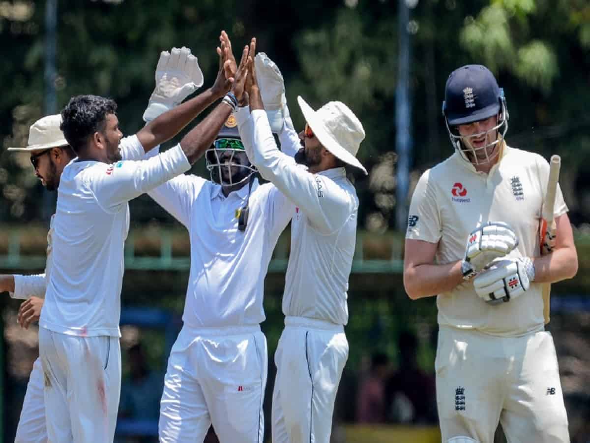 Sri Lanka Board President's XI Ramesh Mendis (2L) celebrates with his teammates after he dismissed England's Dom Sibley (R) during the opening day of a four-day practice match between Sri Lanka Board President's XI and England at the P. Sara Oval Cricket Stadium in Colombo on March 12, 2020. - England will play two test matches against Sri Lanka during their tour of Sri Lanka under the ICC World Test Championship. (Photo by LAKRUWAN WANNIARACHCHI / AFP)