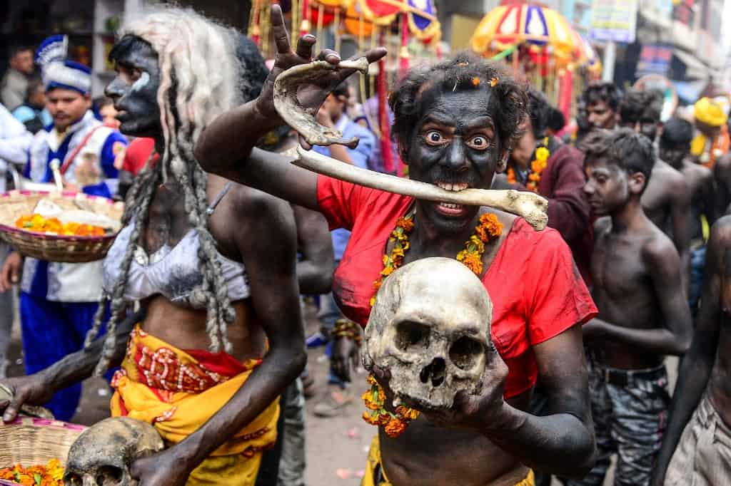 A Hindu devotee of Lord Shiva holds human skull and bone as he takes part in a religious procession to mark the Hindu festival of Maha Shivratri in Allahabad on February 21, 2020. SANJAY KANOJIA / AFP