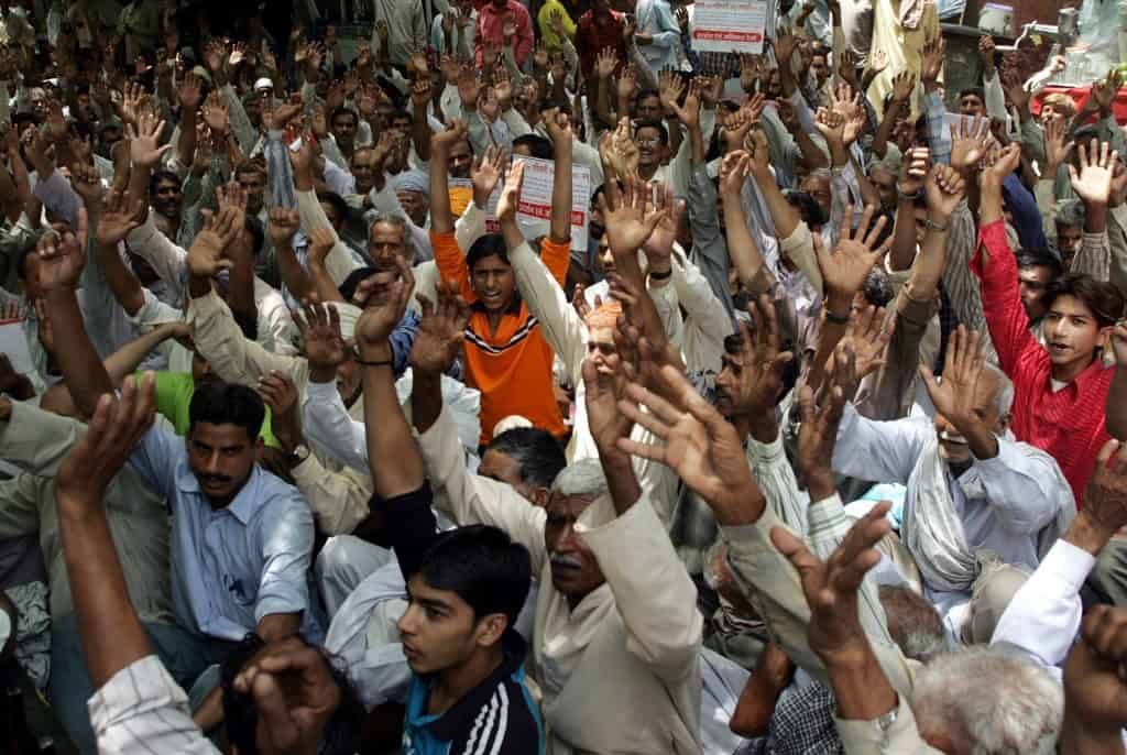 West Pakistani Hindu refugees shout slogans as they take part in a Human Rights demonstration near Parliament House in New Delhi, 18 May 2006. Hundreds of protesters demanded that the Indian government provide them with housing, land, government jobs and free education. AFP PHOTO/RAVEENDRAN (Photo by RAVEENDRAN / AFP)