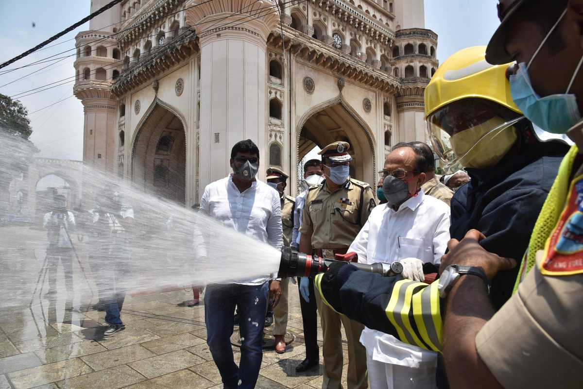 HM Mahmood Ali sprays disinfectant at Charminar