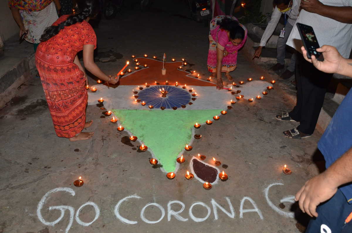 People light candles, diyas to mark fight against COVID-19