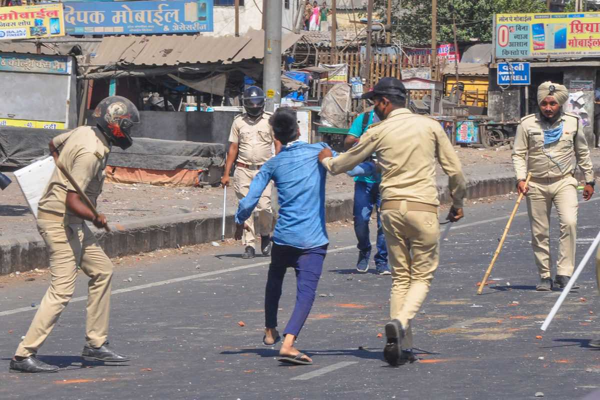 Photos: Migrants clash with police in Surat
