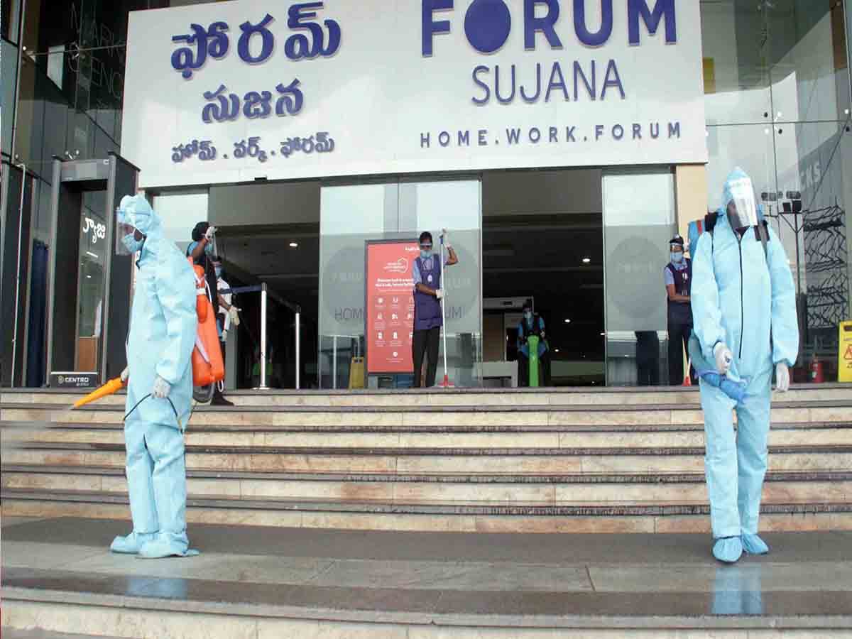 Staff of Forum Sujana Mall spraying disinfectants at the mall entrance in Hyderabad. Photo: Mohammed Hussain