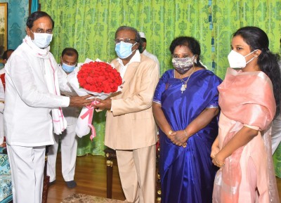 Telangana CM felicitates Governor's husband for award