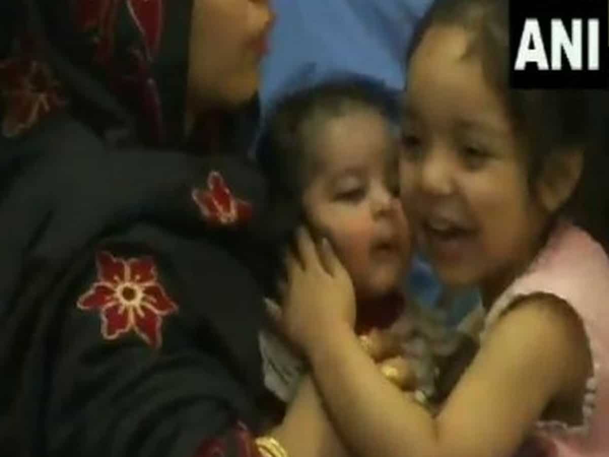 Watch: Young girl kisses infant with joy after reaching India from Kabul