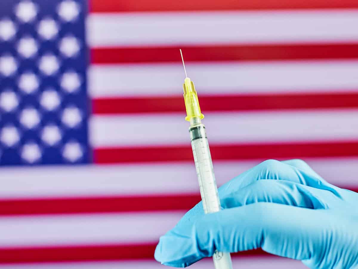 US hits 70% vaccination rate a month late, amid a surge